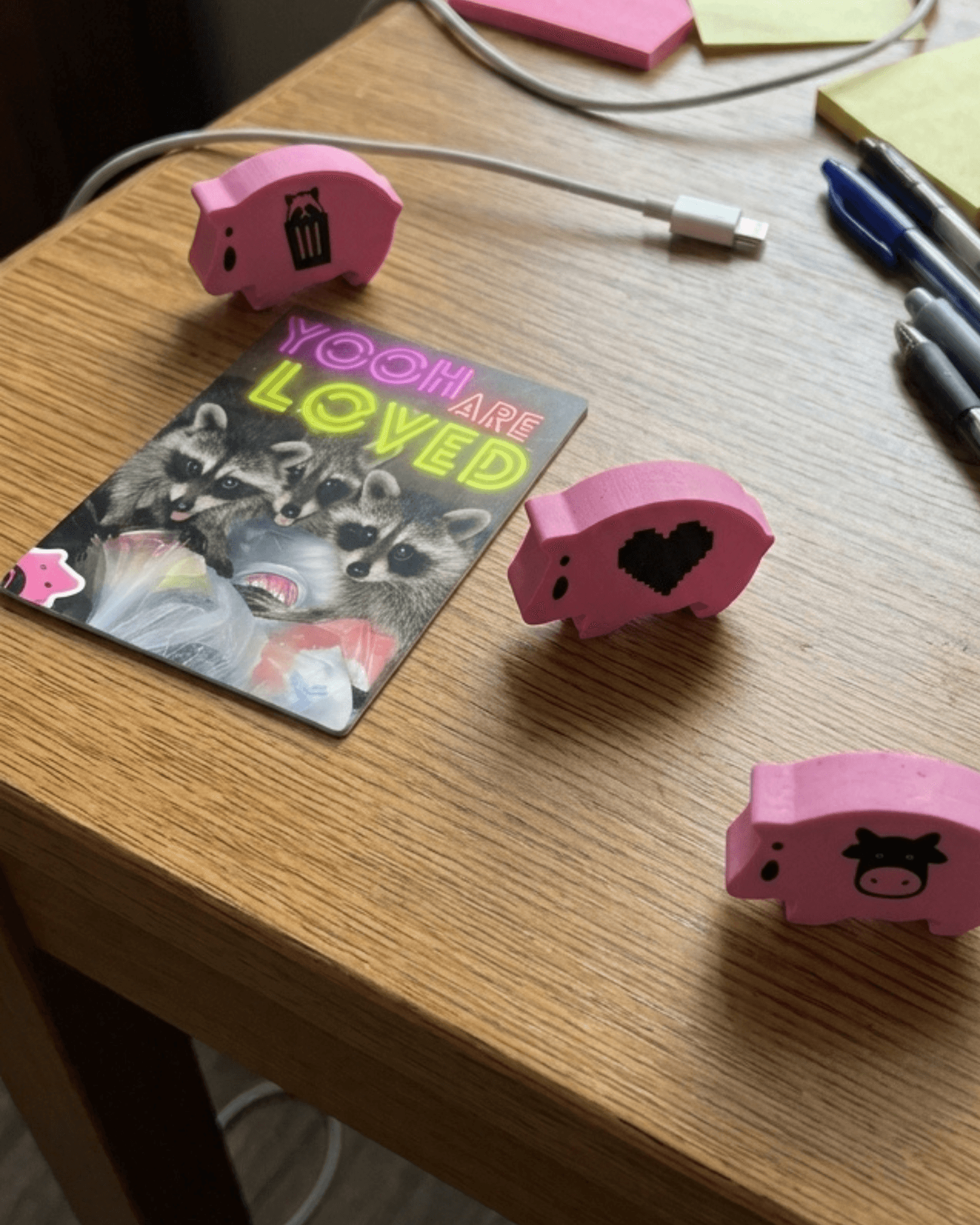 one age hams card and three tiny pink hams on a desk